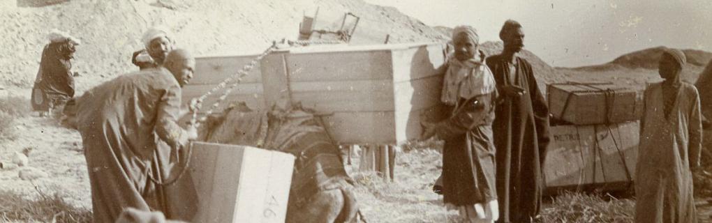 Men packing crates of finds from excavations directed by Flinders Petrie. Date unknown. Petrie Museum archives.